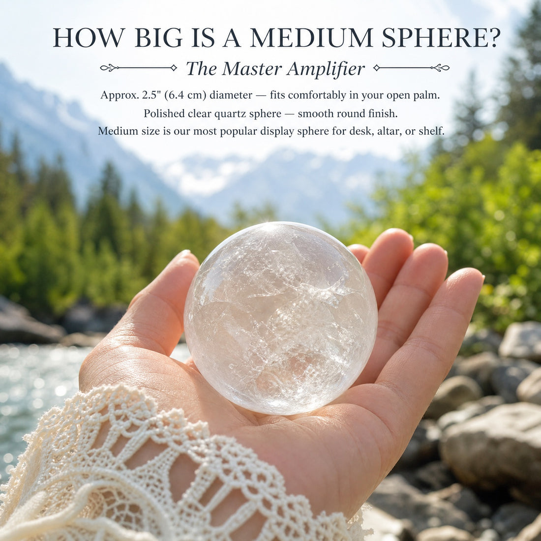 A medium clear quartz sphere resting in an open palm beside a mountain stream