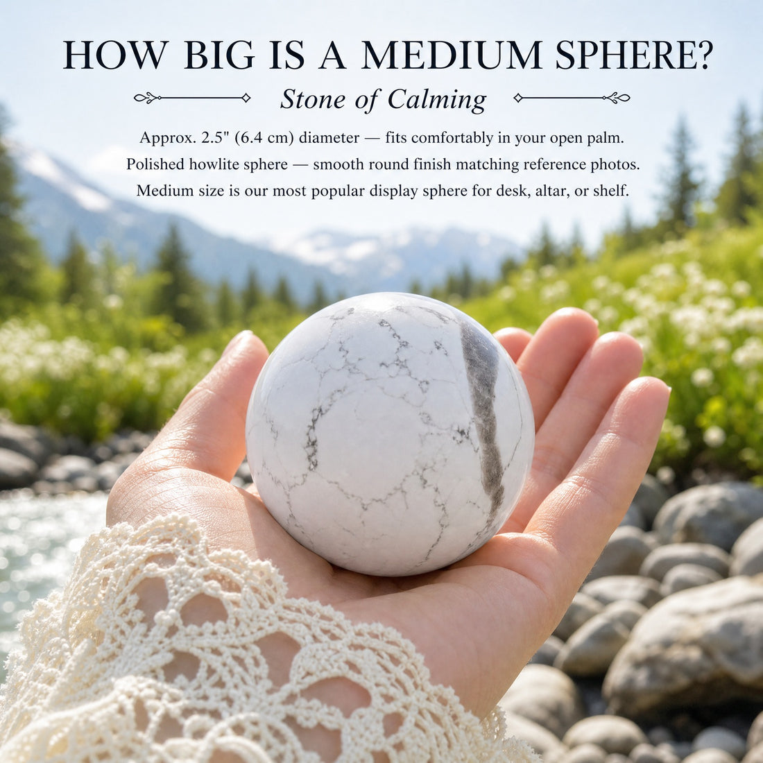A medium howlite sphere resting in an open palm beside a mountain stream