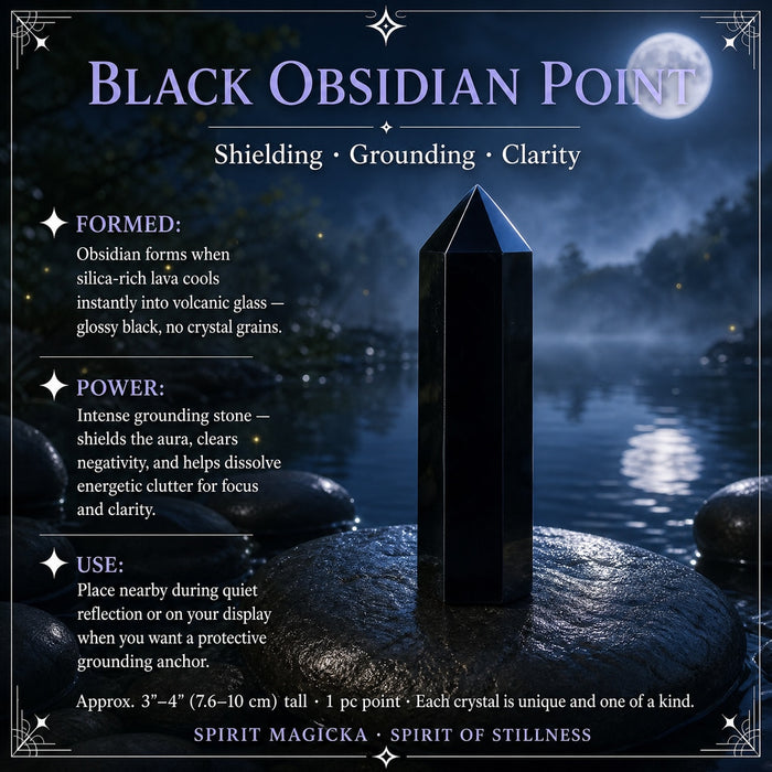 Six-sided black obsidian point standing on a stone by moonlit water