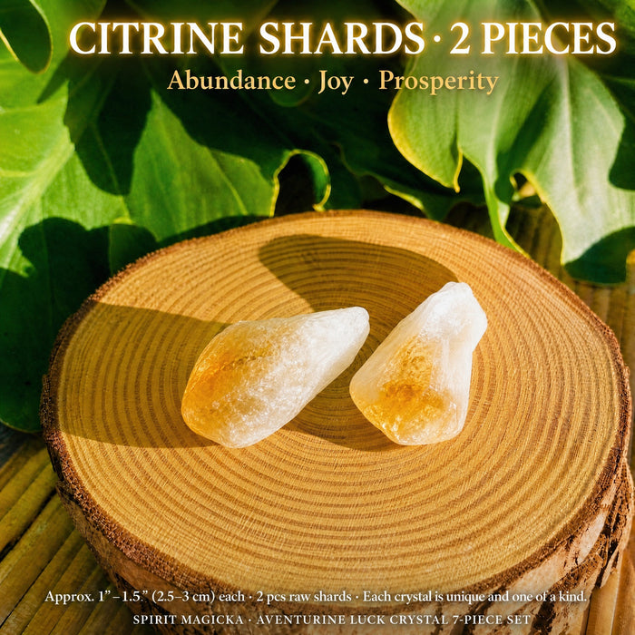 Two raw citrine shards, milky white with honey-gold tips, on a wood round