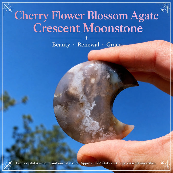 Cherry flower blossom agate crescent moon held up against a blue sky