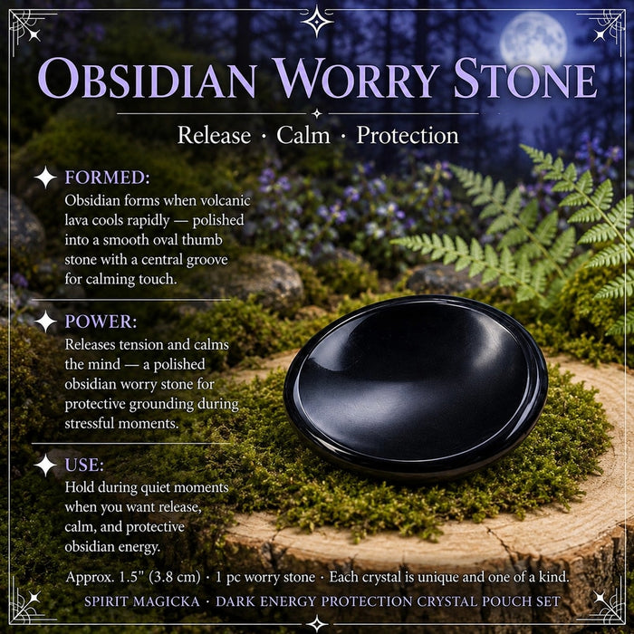 A polished oval obsidian worry stone with a smooth thumb groove, resting on moss