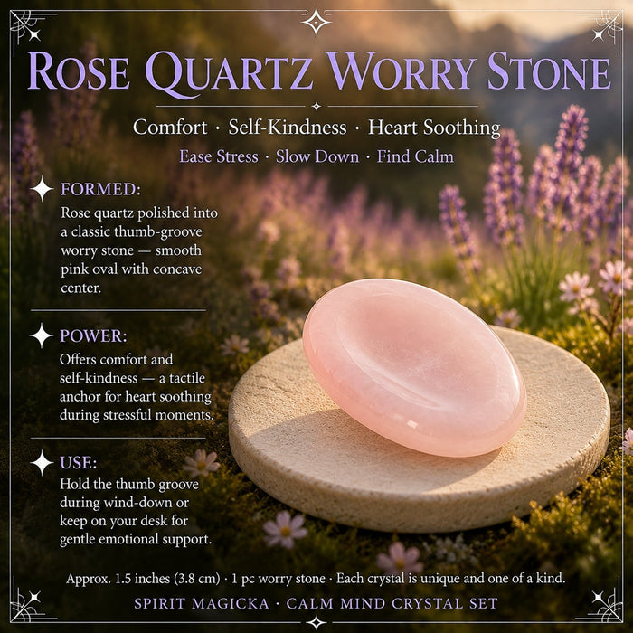 A pink rose quartz worry stone with a smooth thumb groove on a stone disc