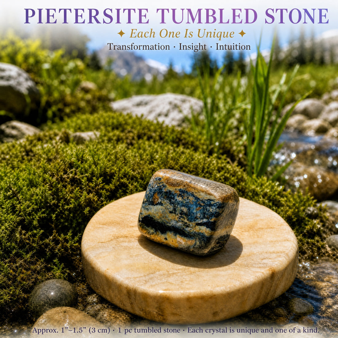 A polished pietersite tumbled stone swirled with gold, copper and deep blue, resting on a stone disc beside moss and a stream