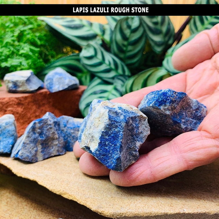 Rough, unpolished pieces of lapis lazuli resting in an open hand