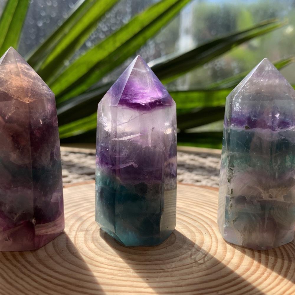 Three multicolor fluorite generators side by side, each with different bands of violet, teal and clear
