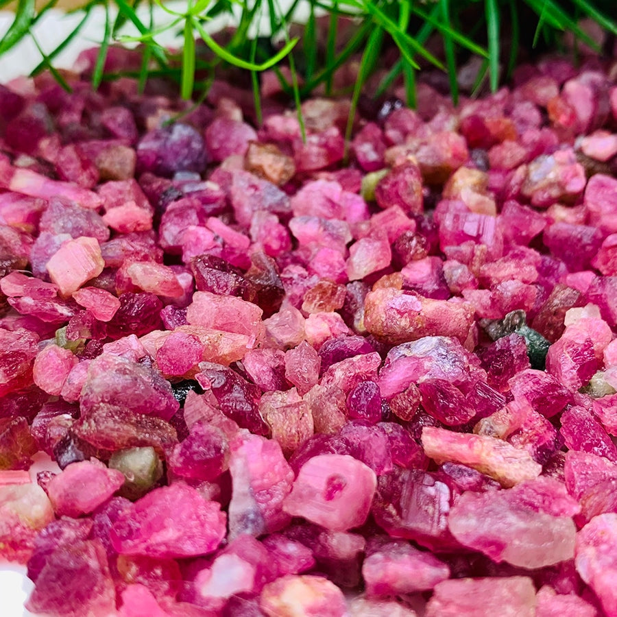 Close-up of rough pink tourmaline pieces in pink, rose, red and violet tones